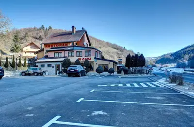 a large building on the side of a road at Apartmani Di Casa Dreams in Donji Vakuf