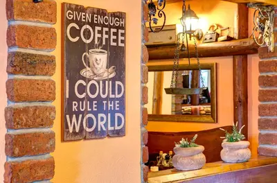a sign on the wall of a coffee shop at Apartmani Di Casa Dreams in Donji Vakuf