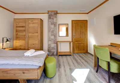 a bedroom with a bed and a desk with a computer at Apartmani Di Casa Dreams in Donji Vakuf