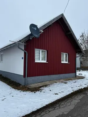 a red and white building with a satellite at Kuca za odmor Marija in Kupres
