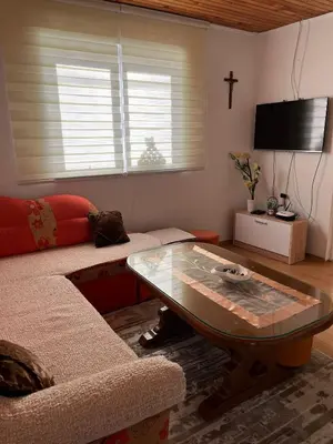 a living room with a couch and a coffee table at Kuca za odmor Marija in Kupres