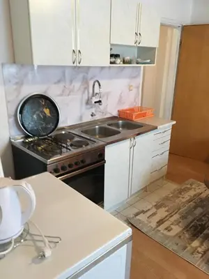 a kitchen with a sink and a stove at Kuca za odmor Marija in Kupres