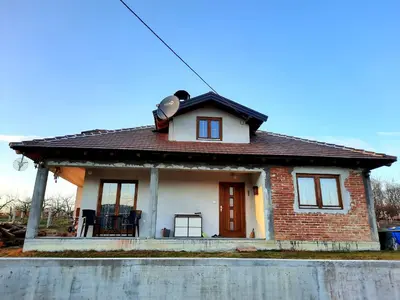 a small brick house with a brown roof at Kuća na dan Vrla strana in Bosansko Petrovo Selo