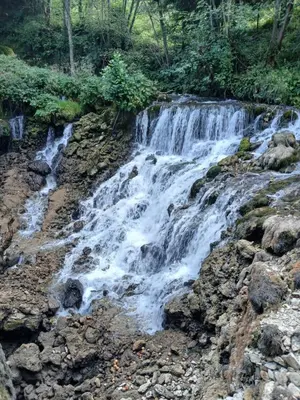a waterfall on the side of a river at Apartmani i sobe 