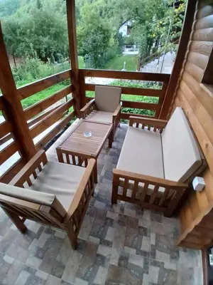 a screened in porch with two chairs and a table at Apartmani i sobe 