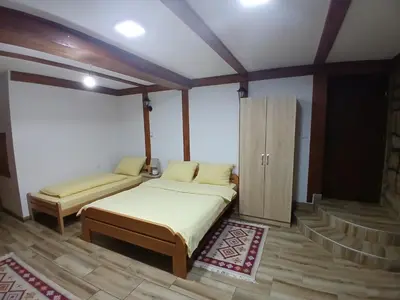 a bedroom with two beds and a cabinet in it at Apartmani i sobe 