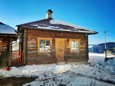 a wooden cabin with snow on the ground at APARTMAN SNOW Vlašić in Vlasic