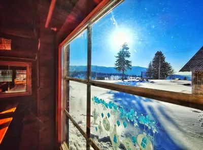 a window with a view of a snow covered yard at APARTMAN SNOW Vlašić in Vlasic