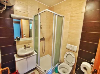 a bathroom with a shower and a toilet and a sink at APARTMAN SNOW Vlašić in Vlasic