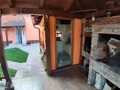 a view of a living room with a stone fireplace at DALMAR Apartman in Bihać