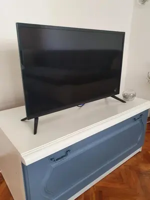 a flat screen tv on a blue and white dresser at Diamond M Apartment in Bihać