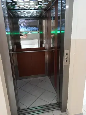 an elevator in a building with a glass door at Apartman MM , Banja Luka, Wi-Fi free,parking free in Banja Luka