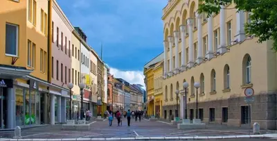 a group of people walking down a street with buildings at Apartman MM , Banja Luka, Wi-Fi free,parking free in Banja Luka