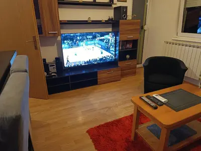 a living room with a tv with a hockey game at Apartman MM , Banja Luka, Wi-Fi free,parking free in Banja Luka
