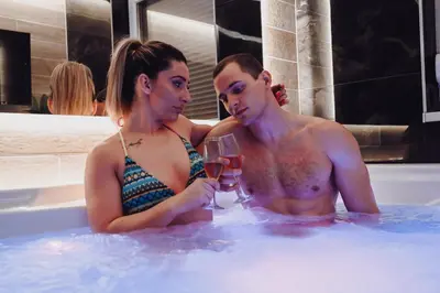 a man and woman sitting in a bath tub at Spa Intimo Doboj in Doboj