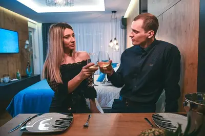 a man and a woman holding glasses of wine at Spa Intimo Doboj in Doboj