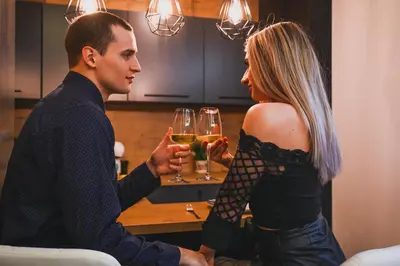 a man and a woman holding glasses of wine at Spa Intimo Doboj in Doboj