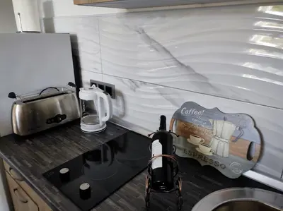 a kitchen with a counter top with a sink at Cozy studio Cik-Cak in Doboj
