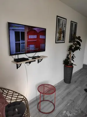 a living room with a tv on a wall at Cozy studio Cik-Cak in Doboj