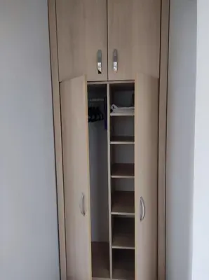 a closet with ajar doors and a mirror at Cozy studio Cik-Cak in Doboj
