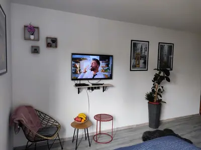 a living room with a tv on a white wall at Cozy studio Cik-Cak in Doboj