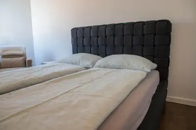 two beds sitting next to each other in a bedroom at Penthouse Linnet Bihać in Bihać