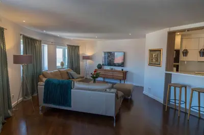 a living room with a couch and a table at Penthouse Linnet Bihać in Bihać