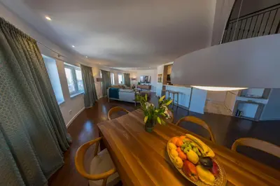 a bowl of fruit on a wooden table in a living room at Penthouse Linnet Bihać in Bihać