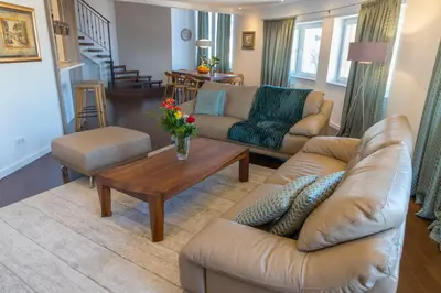 a living room with couches and a coffee table at Penthouse Linnet Bihać in Bihać