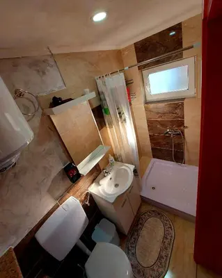 a bathroom with a toilet and a sink and a tub at Apartments Marshal in Bosanska Krupa