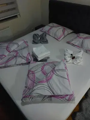 a white table with four pillows on it at LNB Lux in Doboj