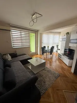 a living room with a couch and a table at LNB Lux in Doboj