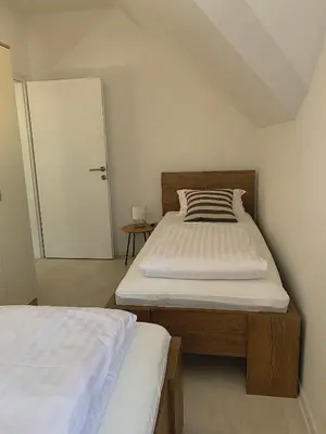 a bedroom with two beds and a sliding door at KARTAL centar apartment in Bihać