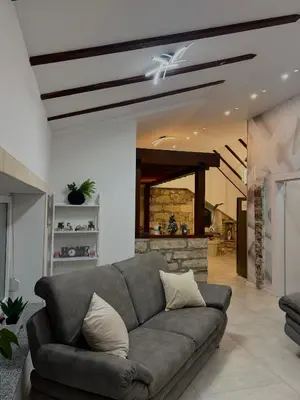a living room with a couch and a fireplace at KARTAL centar apartment in Bihać