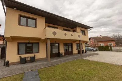a house with a table in front of it at Pansion San in Bihać