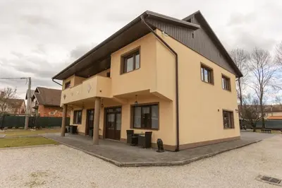 a large house with a black roof at Pansion San in Bihać