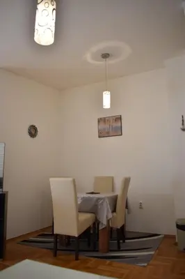 a dining room with a table and chairs at Apartman Archive Jevrejska in Banja Luka