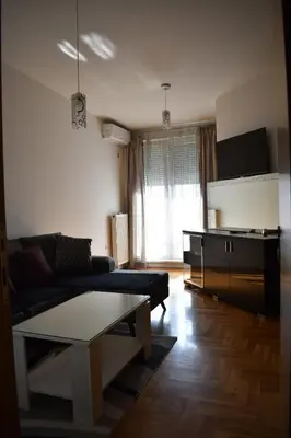 a living room with a couch and a table at Apartman Archive Jevrejska in Banja Luka