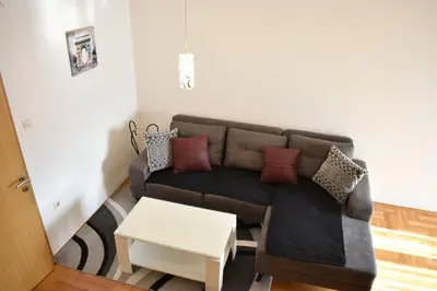 a living room with a couch and a table at Apartman Archive Jevrejska in Banja Luka