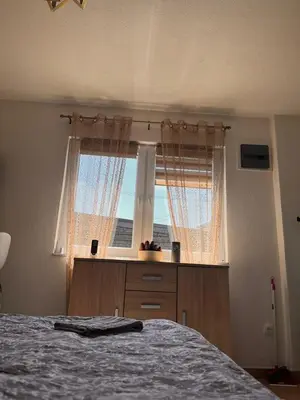 a bedroom with a bed and a window at City apartment 2 in Visoko