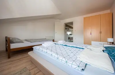 a large bedroom with two beds in it at Apartman Luca in Livno