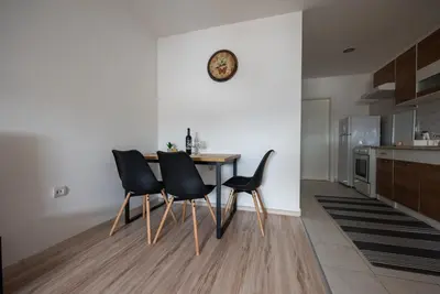a kitchen with a table and chairs in a room at Apartman Luca in Livno
