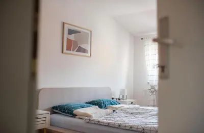 a bedroom with a bed and a picture on the wall at Apartman Luca in Livno