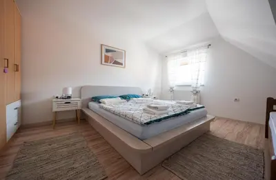a bedroom with a large bed and a window at Apartman Luca in Livno