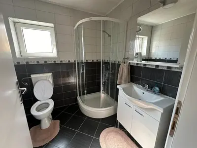 a bathroom with a toilet and a sink and a shower at Apartman Anđela in Livno