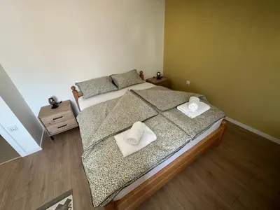 a bedroom with a bed with two towels on it at Apartman Anđela in Livno