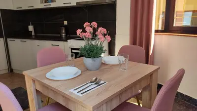 a wooden table with plates and napkins on it at NETWORK apartment in Jajce