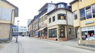 an empty street in a city with a building at NETWORK apartment in Jajce