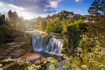 a waterfall in the middle of a river at NETWORK apartment in Jajce