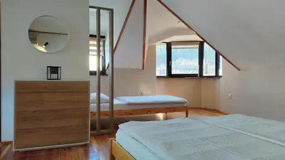 a bedroom with a bed and a mirror at NETWORK apartment in Jajce